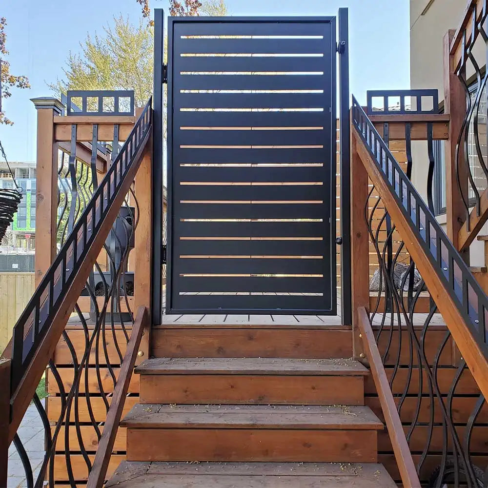 Black horizontal slat gate with metal frame and decorative wrought iron railings.