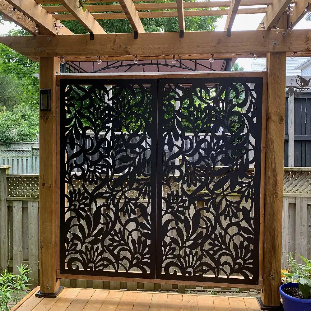 Black metal gate with intricate floral design, modern style.