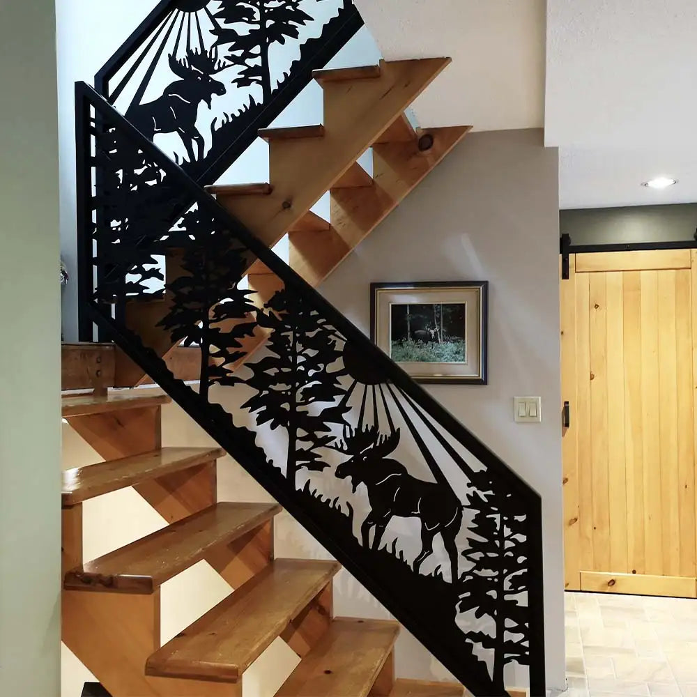 Black metal moose-themed stair railing with intricate forest design, rustic wood stairs.