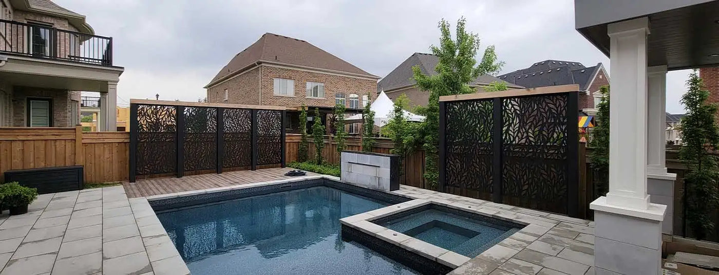 Black metal privacy screen with intricate cutouts, modern design.