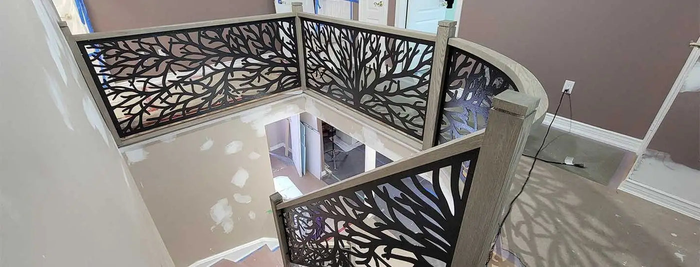 Curved metal railing with intricate floral design, silver finish.