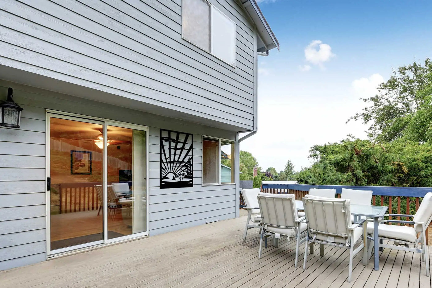 White patio furniture set with cushioned seats and backrests, made of durable plastic material.