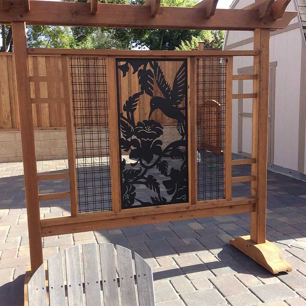 Wooden hummingbird screen door with metal mesh and decorative cutout design.