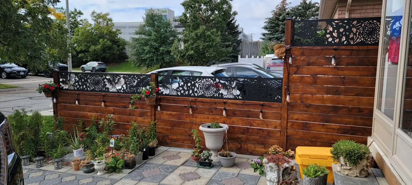 Wooden privacy fence with decorative metal accents, dark brown stain