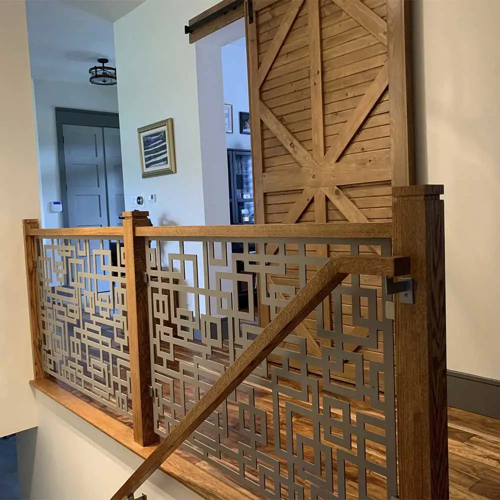 Wooden staircase railing with geometric lattice design and natural wood finish.
